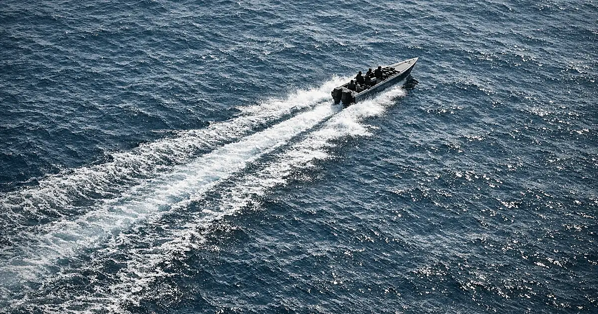 Aerial view of speedboat creating wake trail across dark ocean waters in Eastern Pacific