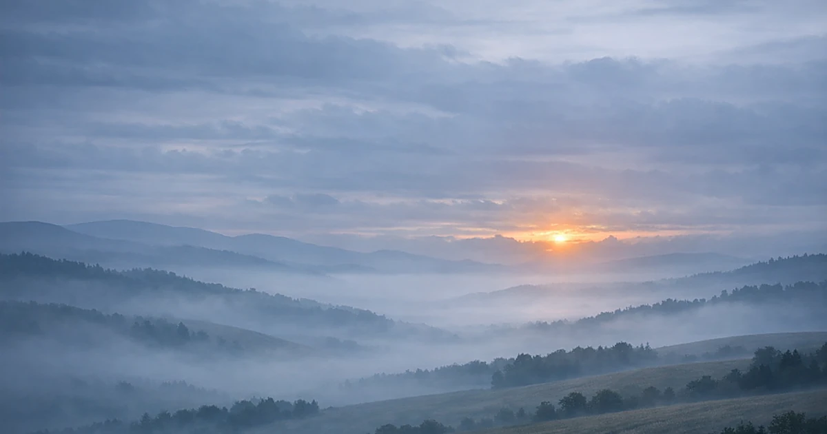 Abstract misty landscape with rolling hills and soft dawn light breaking through clouds